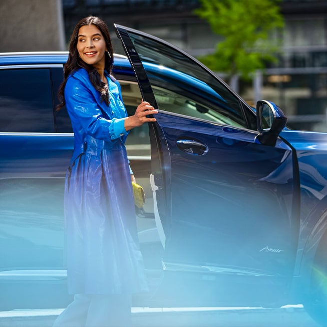 A woman entering a vehicle