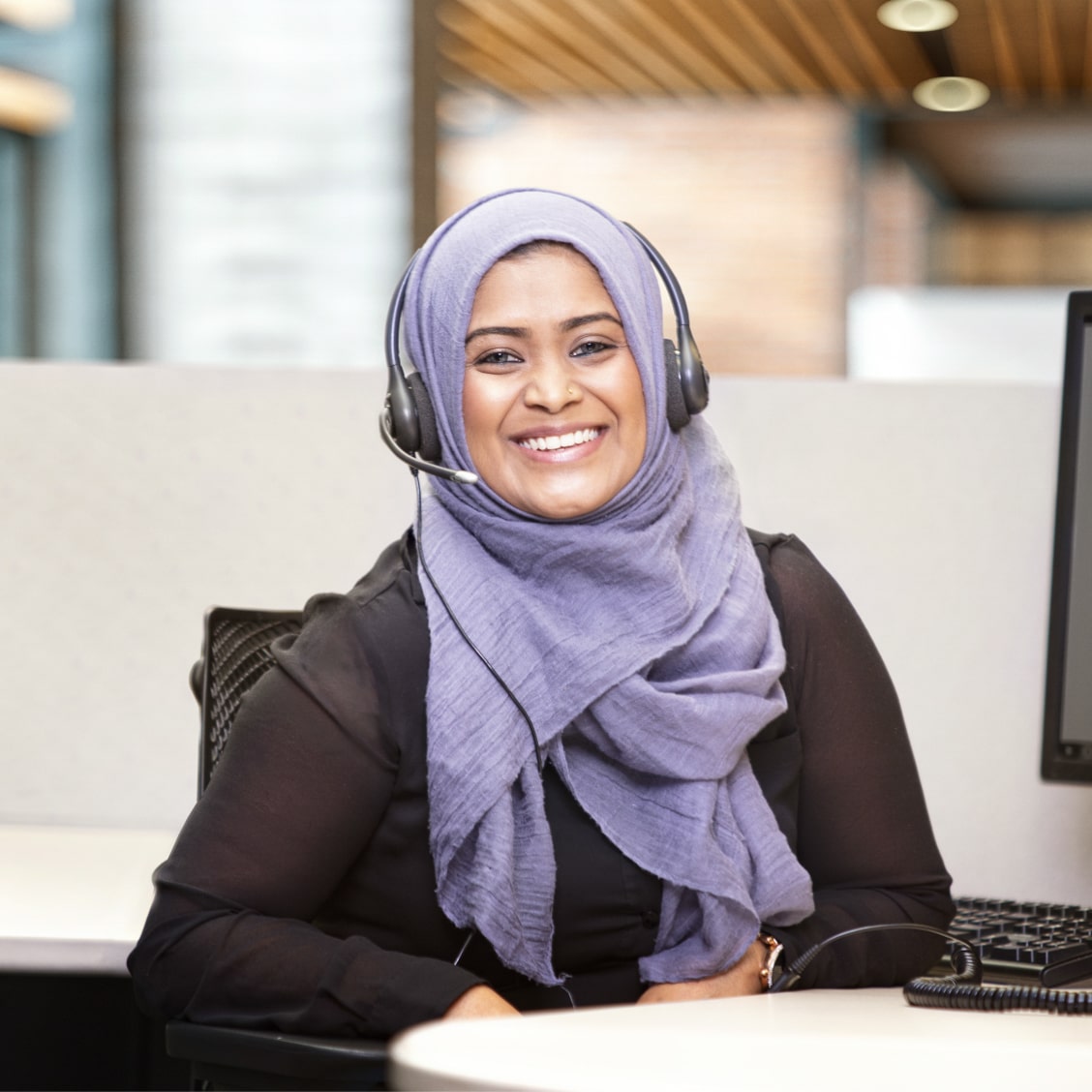 Female OnStar Advisor Smiling with Headset on