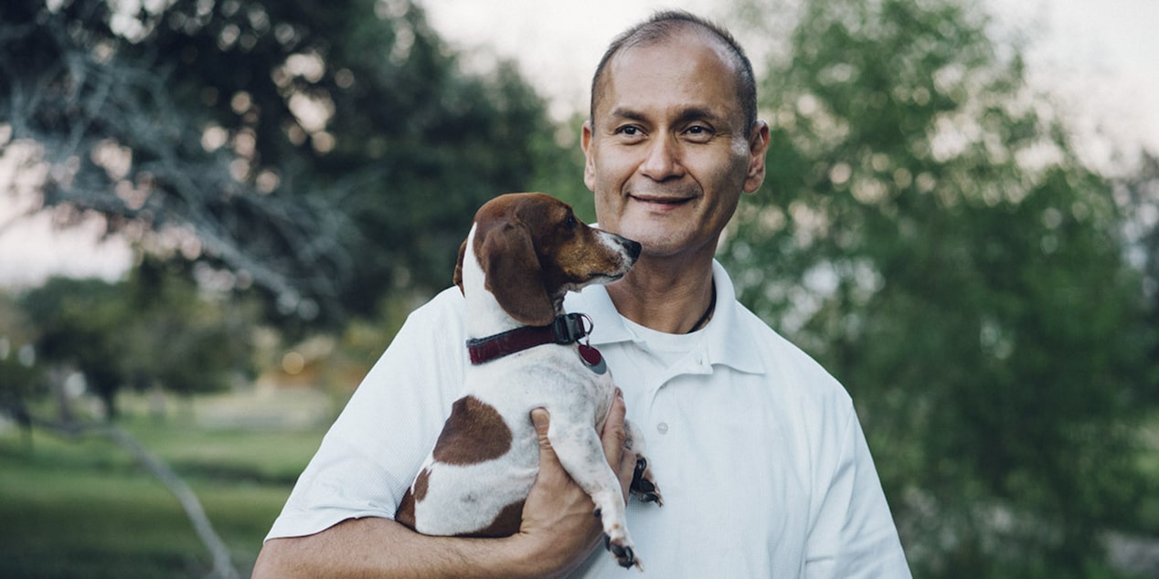 Man Holding Dog Smiling