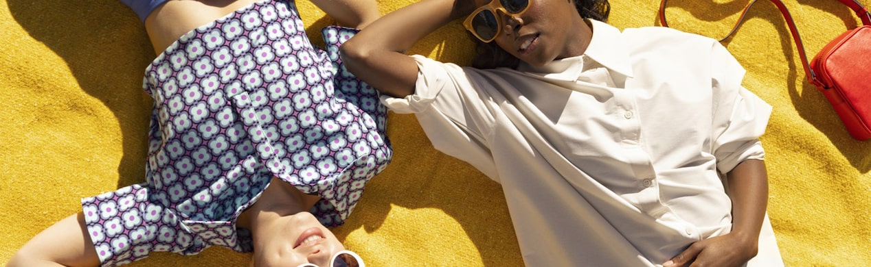 Women Laying out in the Sun on a Yellow Blanket