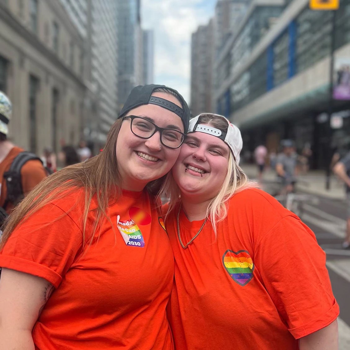 Two Women Posing for Picture with LGBTQ Pins on